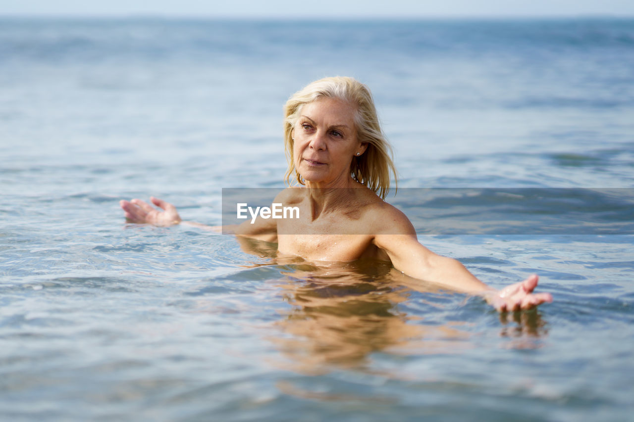 Senior woman swimming in sea