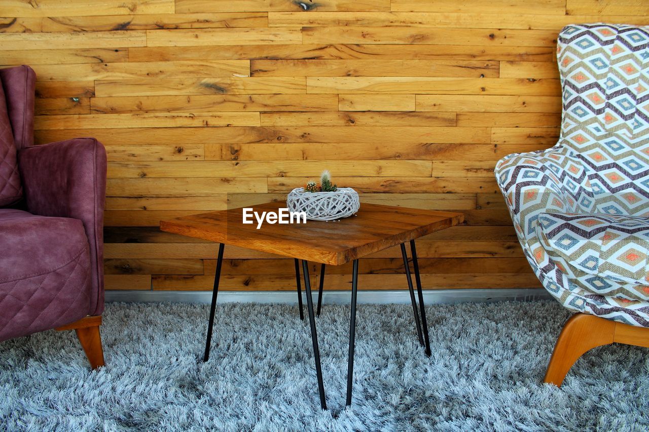 High angle view of table and chairs on floor at home