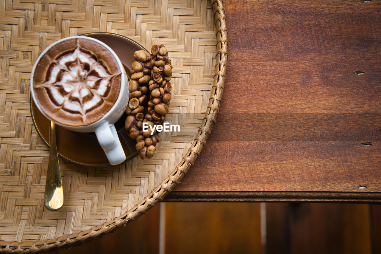 HIGH ANGLE VIEW OF COFFEE ON TABLE AT HOME