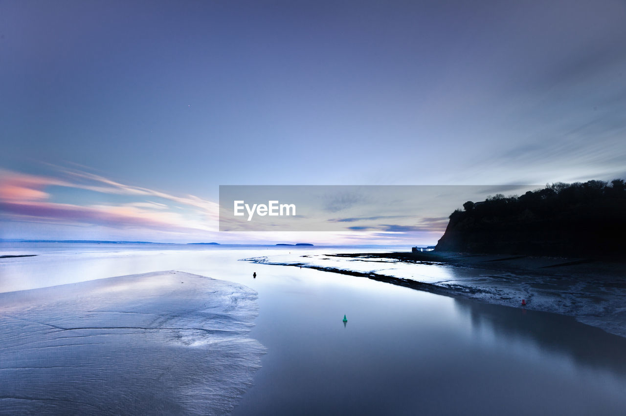 View of mountain and river at dramatic sunset