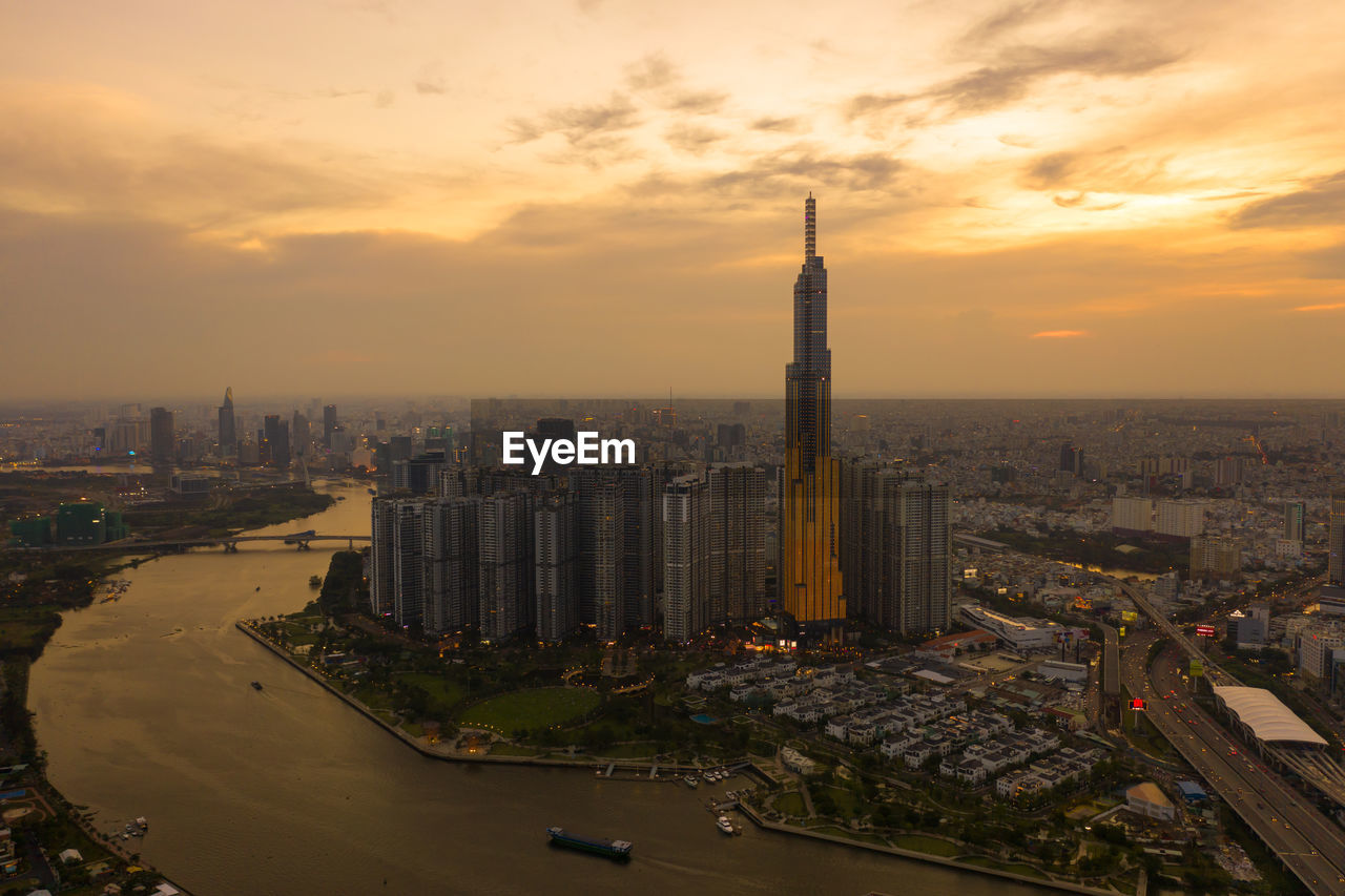 High angle view of buildings in city during sunset