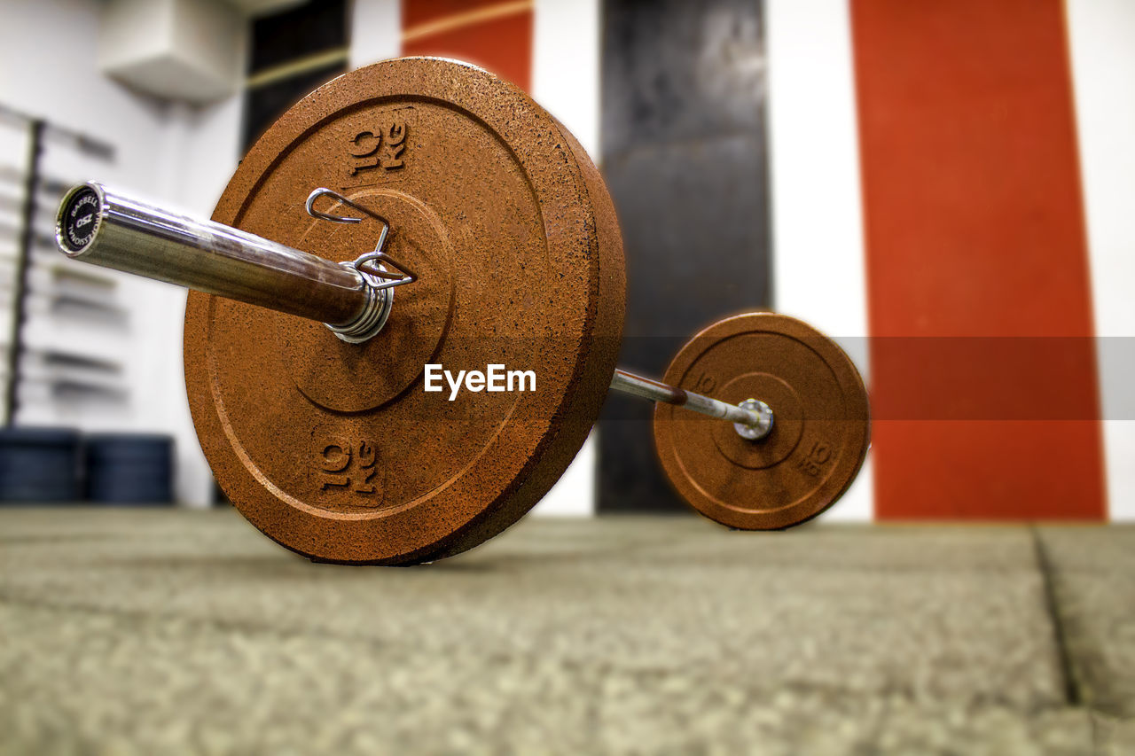 Surface level on barbell on floor in gym