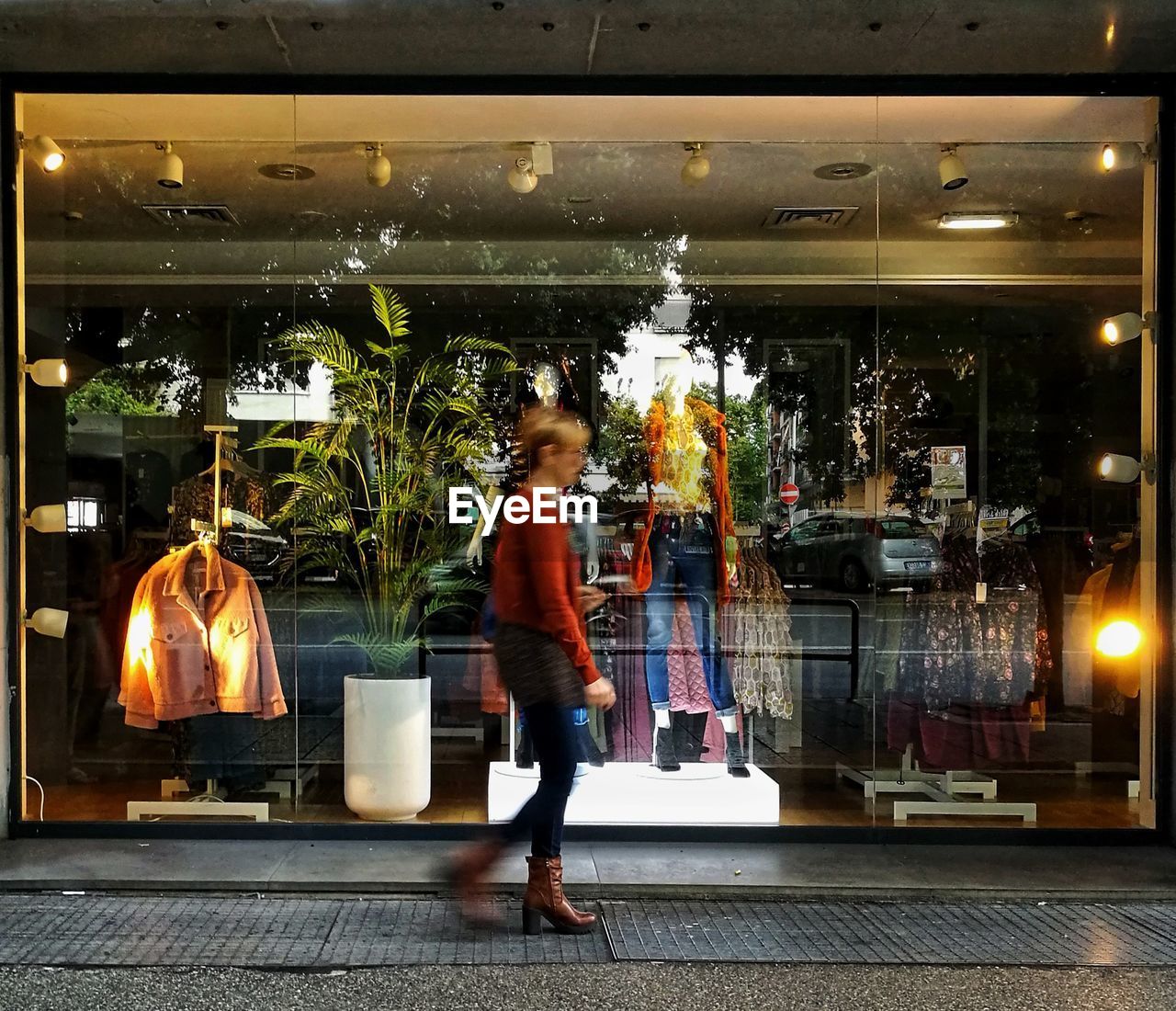 WOMAN STANDING AT SHOPPING MALL