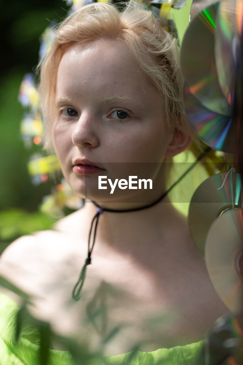 Close-up of girl looking away in a neon green handmade crown