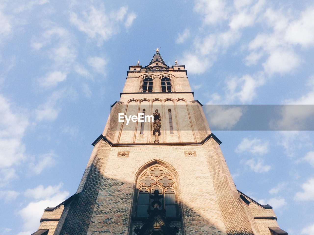 Low angle view of bell tower against sky