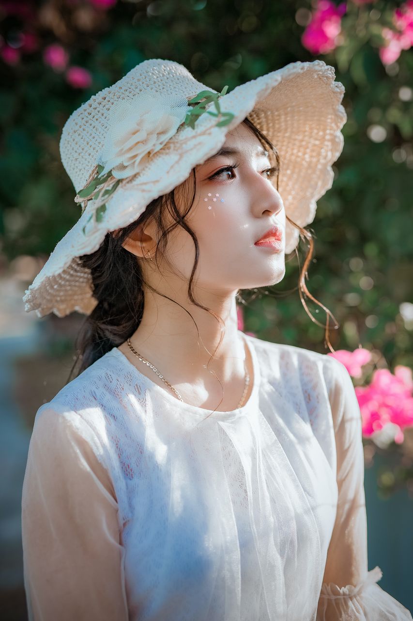 Portrait of young woman wearing hat