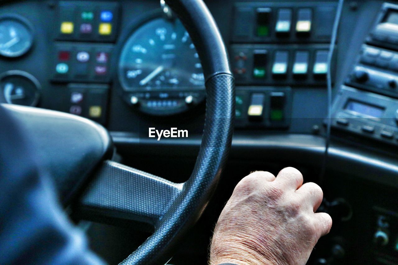 CLOSE-UP OF HUMAN HAND ON CAR