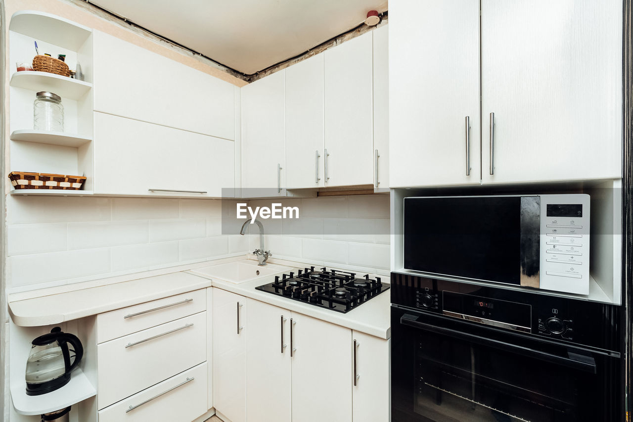 Modern white kitchen with gas stove