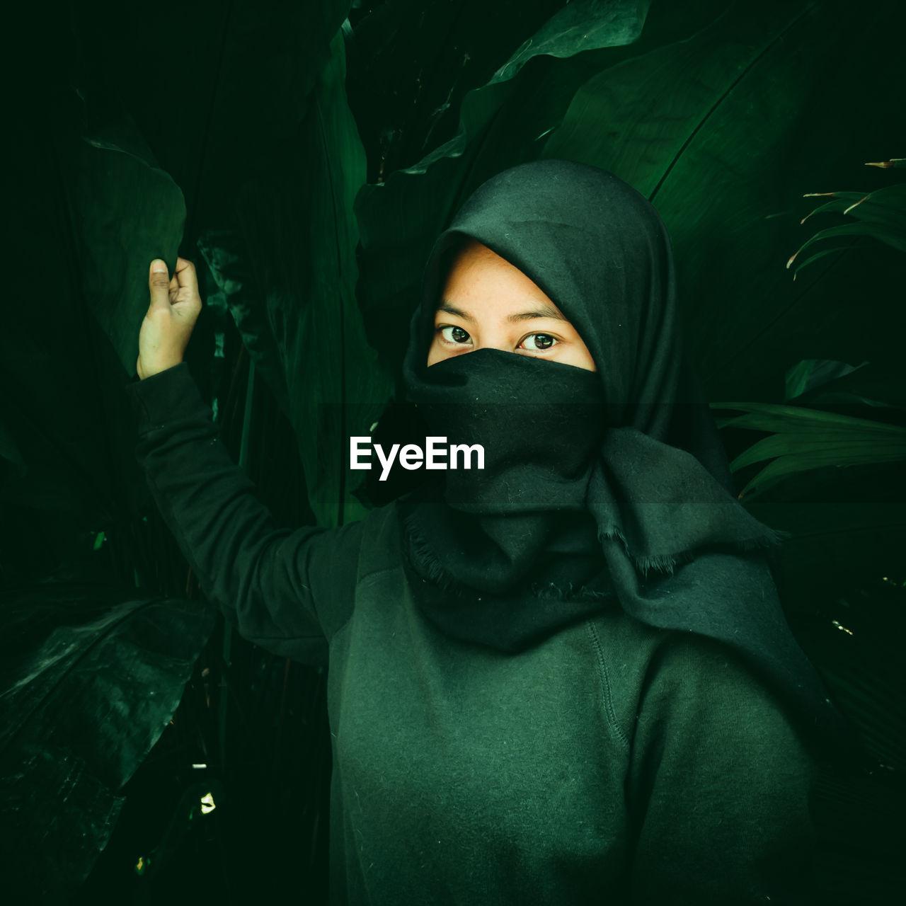 Veiled woman with a dark green effect