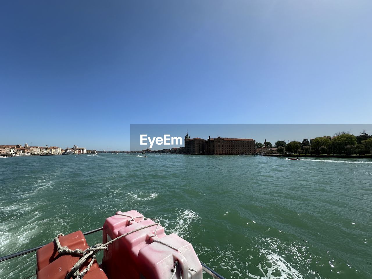 water, boat, sea, transportation, sky, nature, vehicle, boating, nautical vessel, architecture, built structure, clear sky, travel destinations, mode of transportation, travel, building exterior, day, vacation, watercraft, blue, outdoors, city, kayak, motion, copy space, tourism, sunny, scenics - nature, coast, no people, beauty in nature, bay, sunlight, land, trip