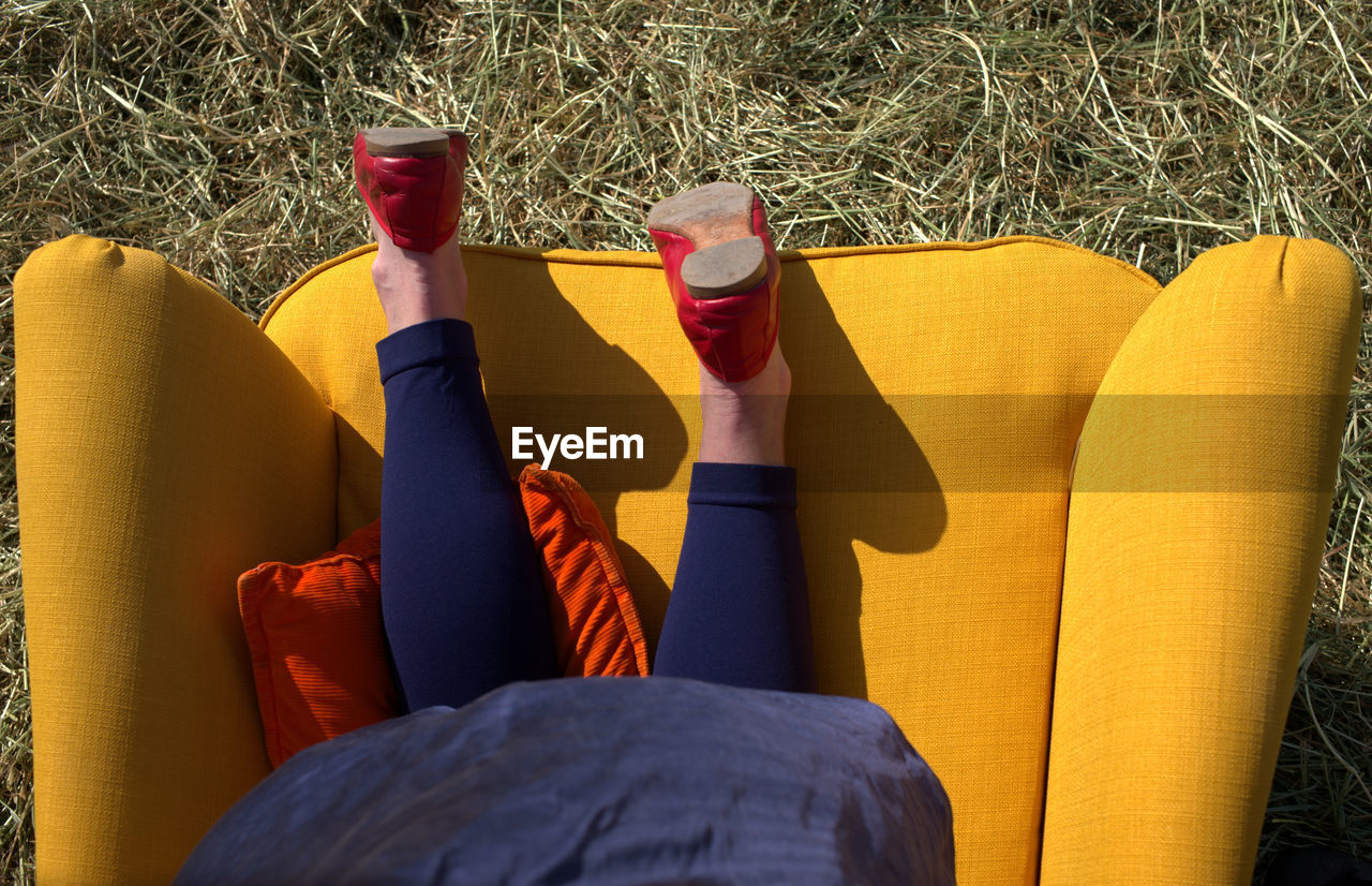 Directly above shot of woman on armchair outdoors