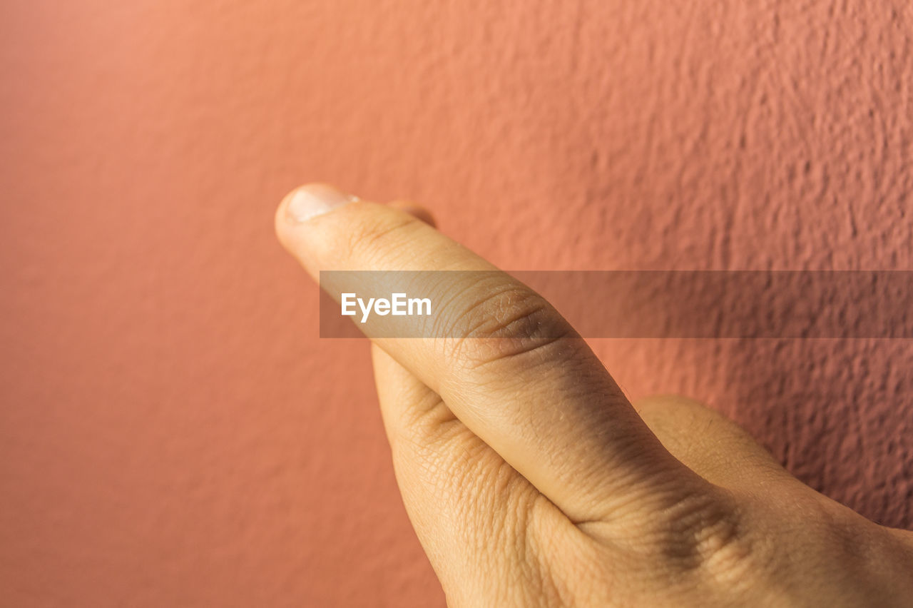 CLOSE-UP OF HAND ON WALL