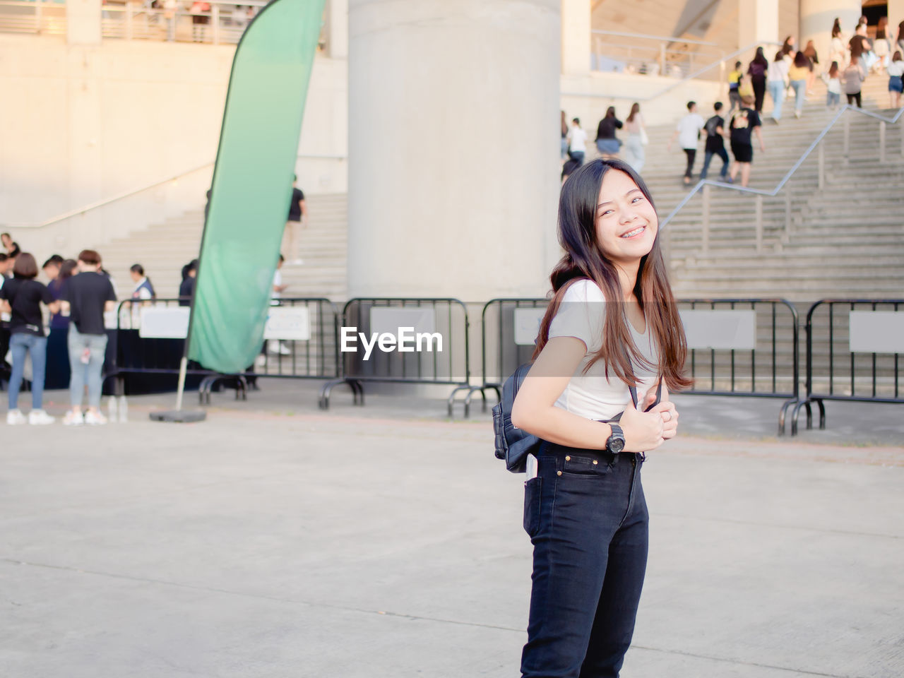 Portrait of happy asian young woman outdoors