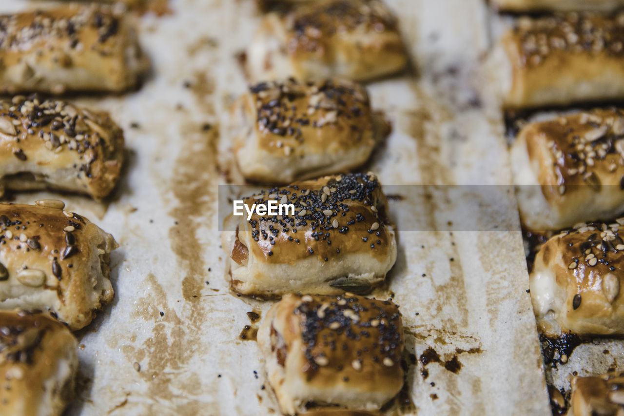 Small buns with sesame on parchment