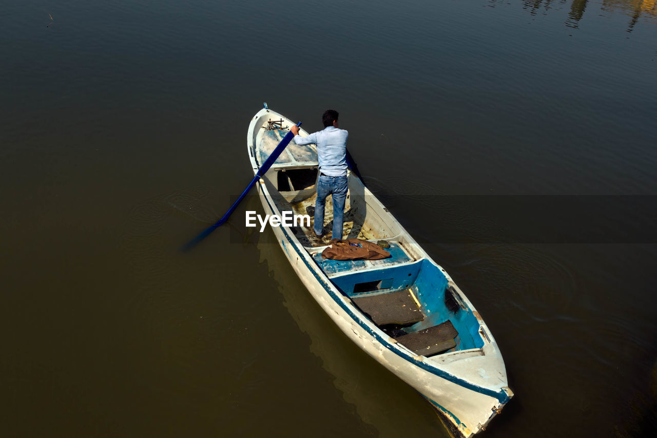 High angle view of man standing on boat