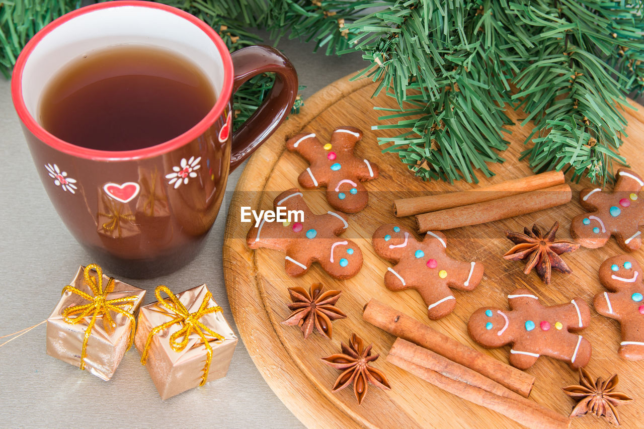 High angle view of gingerbread cookies and spices on table