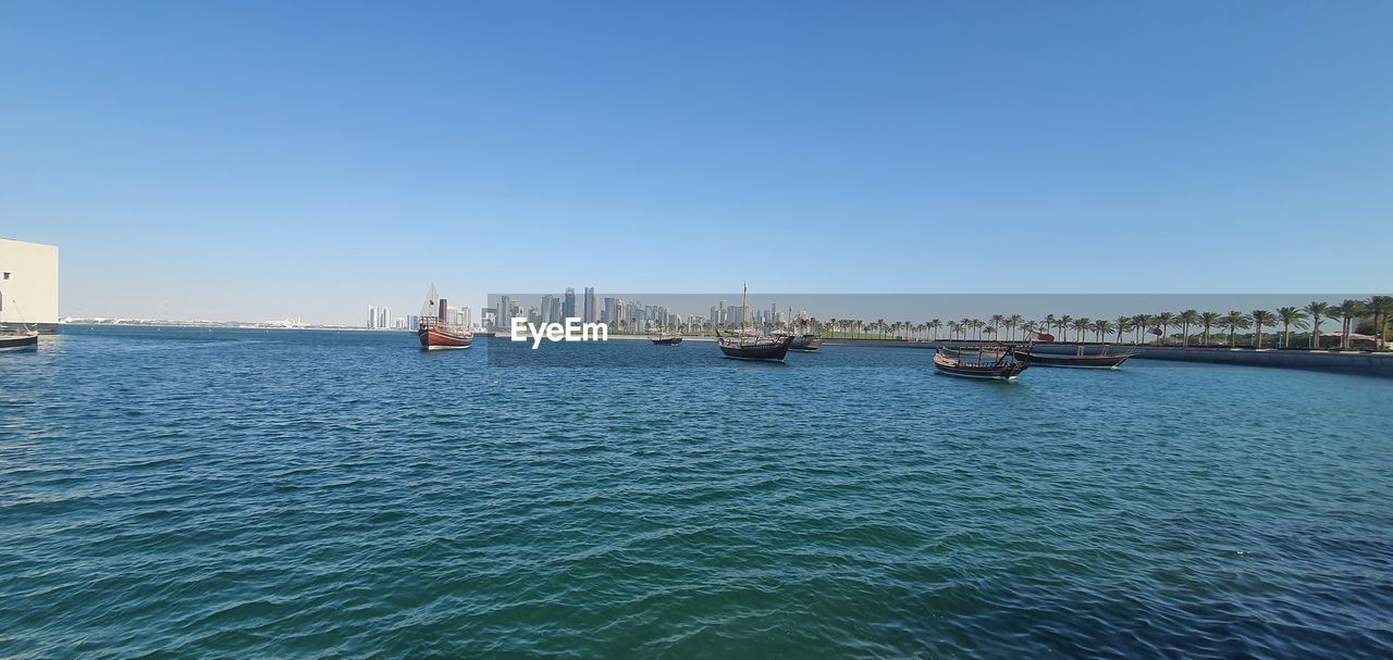 water, transportation, nautical vessel, sea, sky, clear sky, mode of transportation, architecture, nature, blue, vehicle, ship, boat, travel, day, bay, travel destinations, harbor, no people, built structure, waterfront, city, marina, copy space, building exterior, coast, outdoors, sailing, shore, sailboat, sunny, dock, craft, scenics - nature, watercraft, horizon, rippled, beauty in nature, tourism, building, ocean, tranquility
