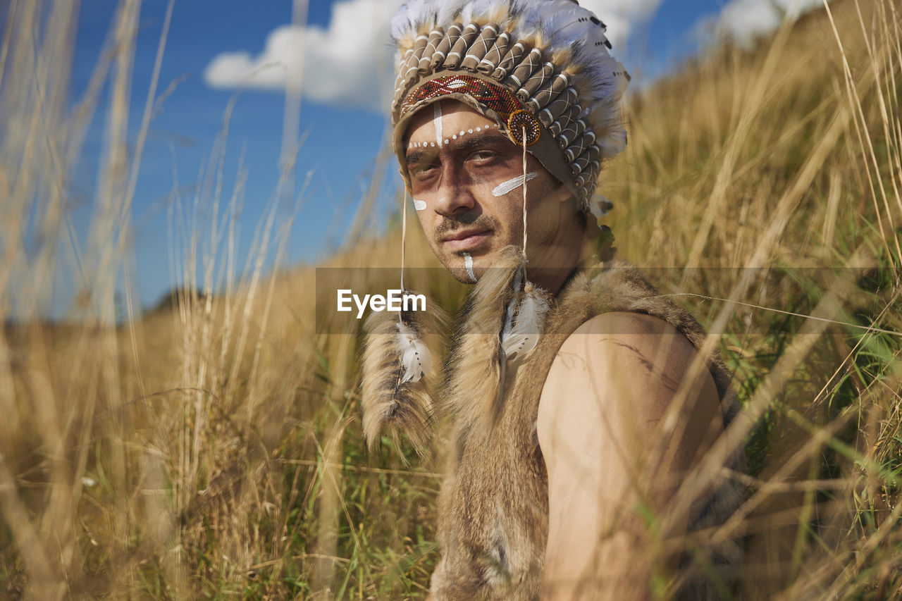 A man in traditional native american clothing in the steppe