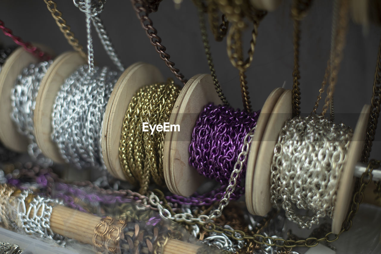 Chain decoration on coils. sale of jewelry. chains wound on reels. different threads for creativity.