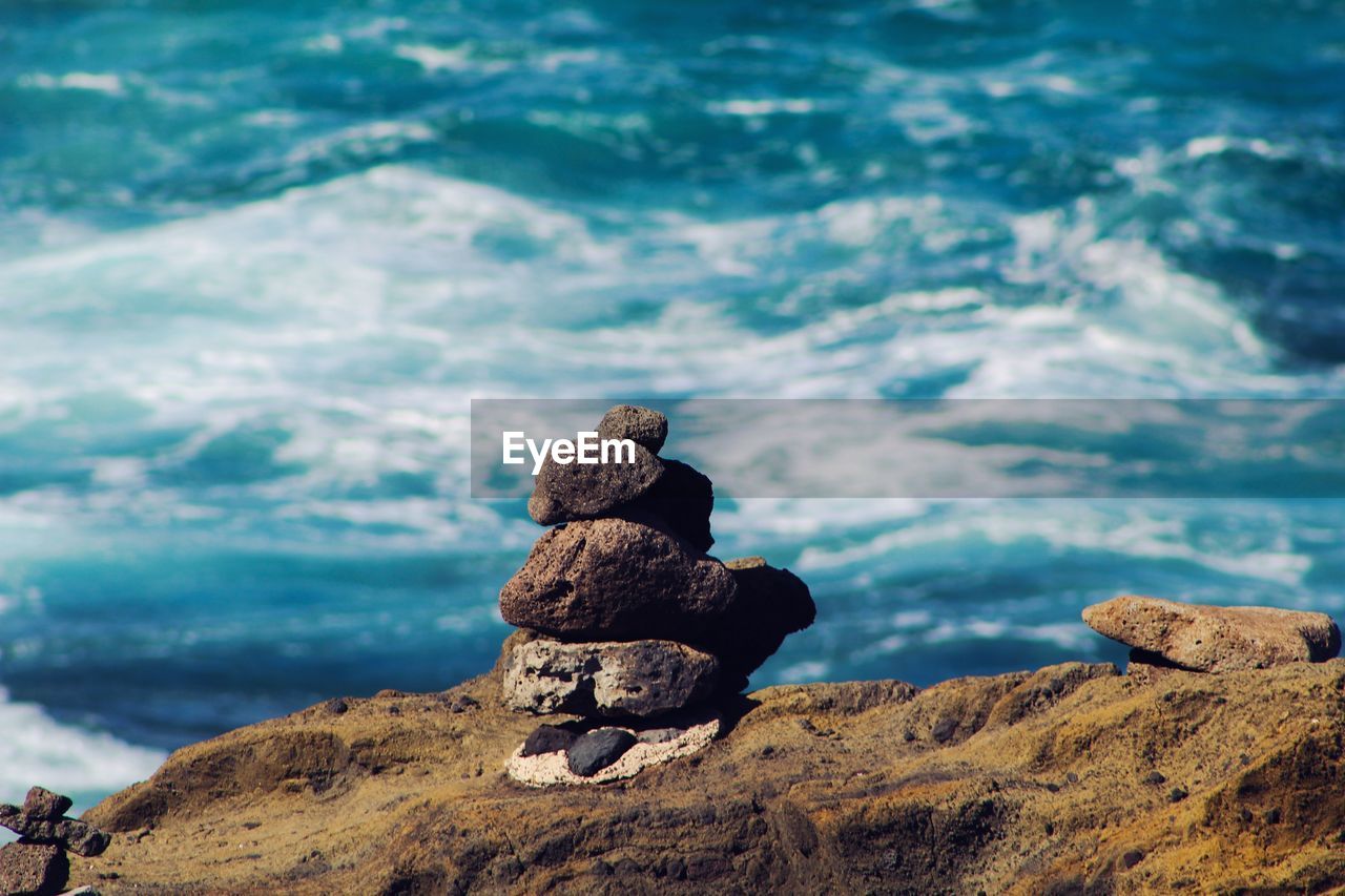 Rocks stacked against sea