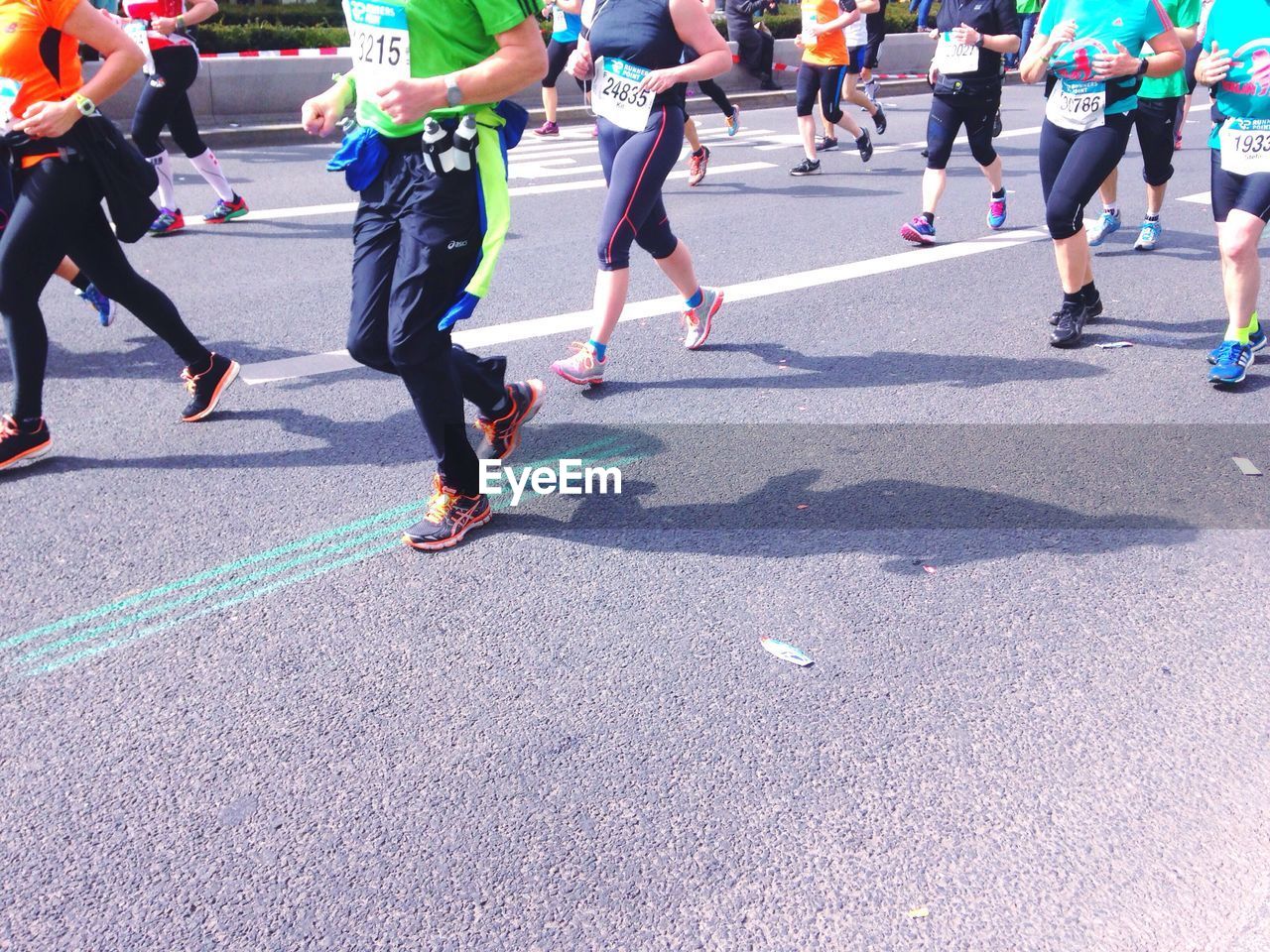 Low section of people running marathon on road