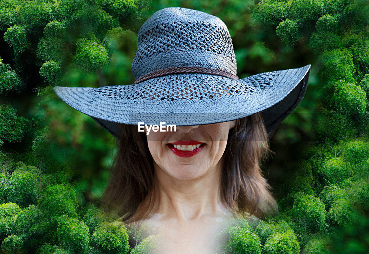 PORTRAIT OF A SMILING YOUNG WOMAN WITH HAT