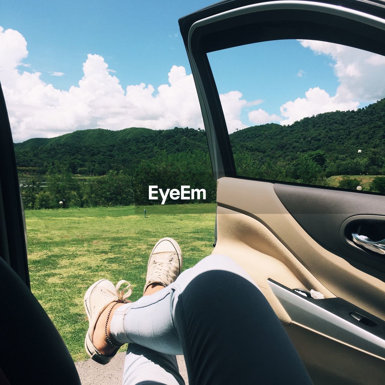 Low section of person sitting in car