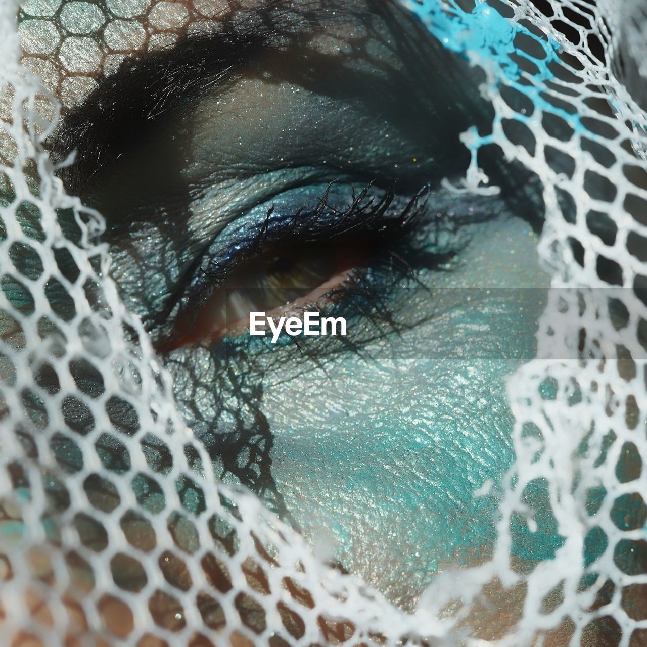 Close-up portrait of woman eye with spooky make-up