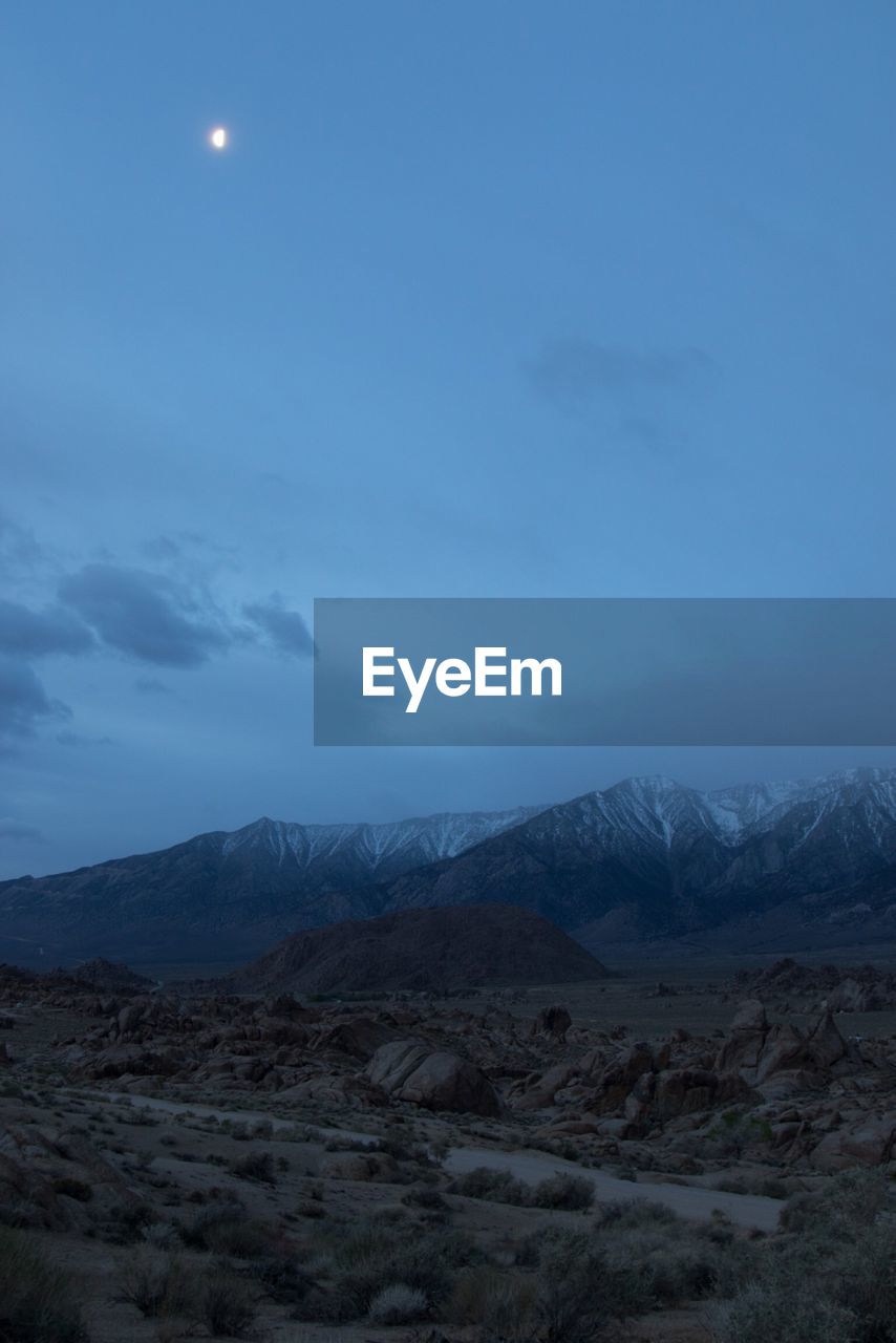 Scenic view of mountains against sky at night