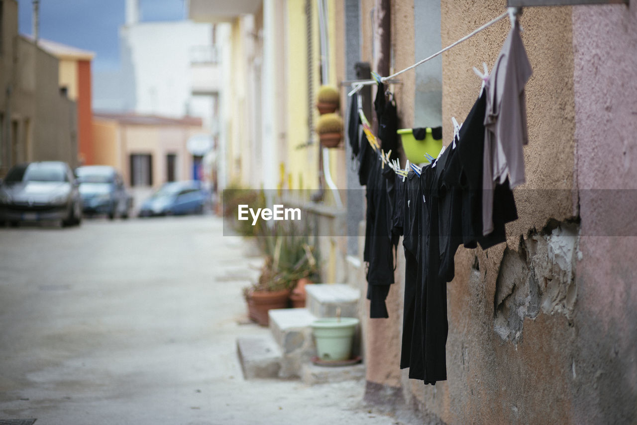 Side view of clothes drying against the wall