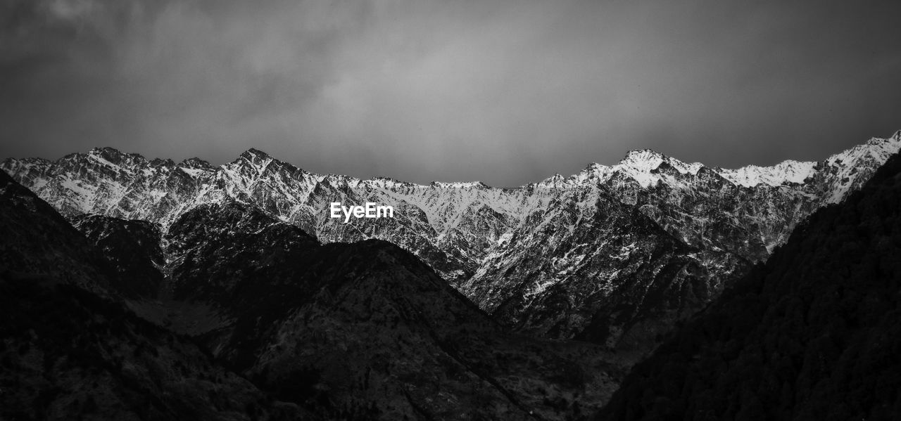 Panoramic view of snowcapped mountains against sky