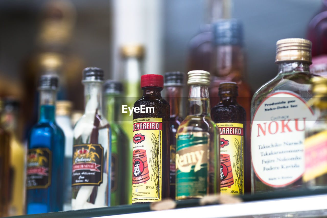 CLOSE-UP OF BOTTLES ON GLASS