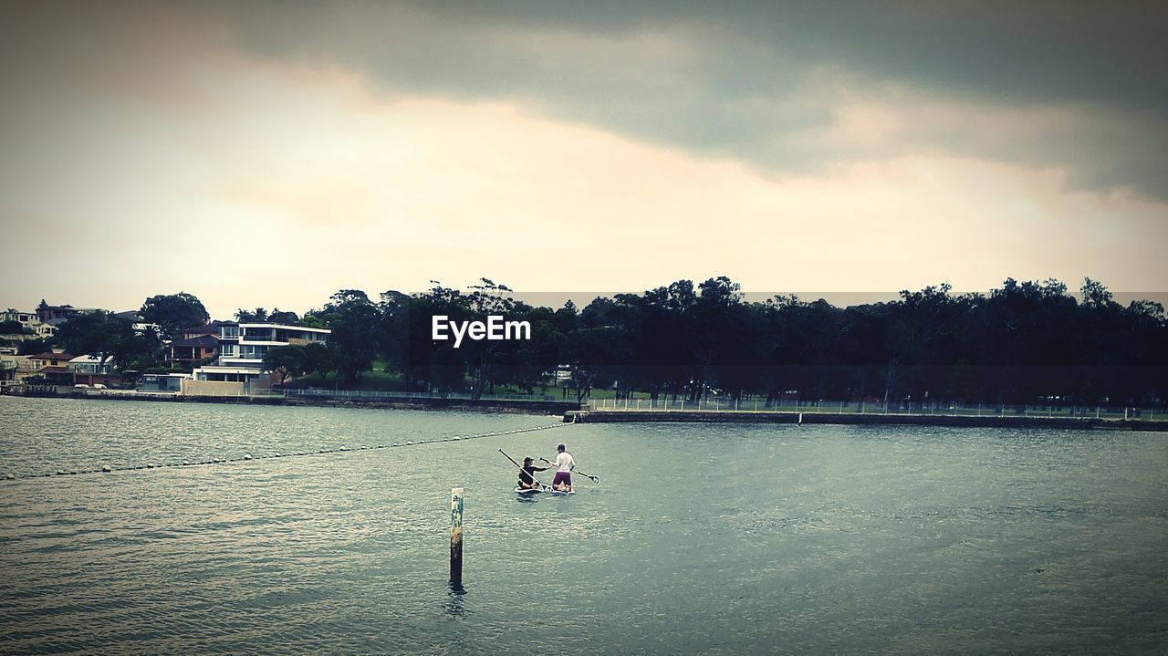 BOATS SAILING IN RIVER