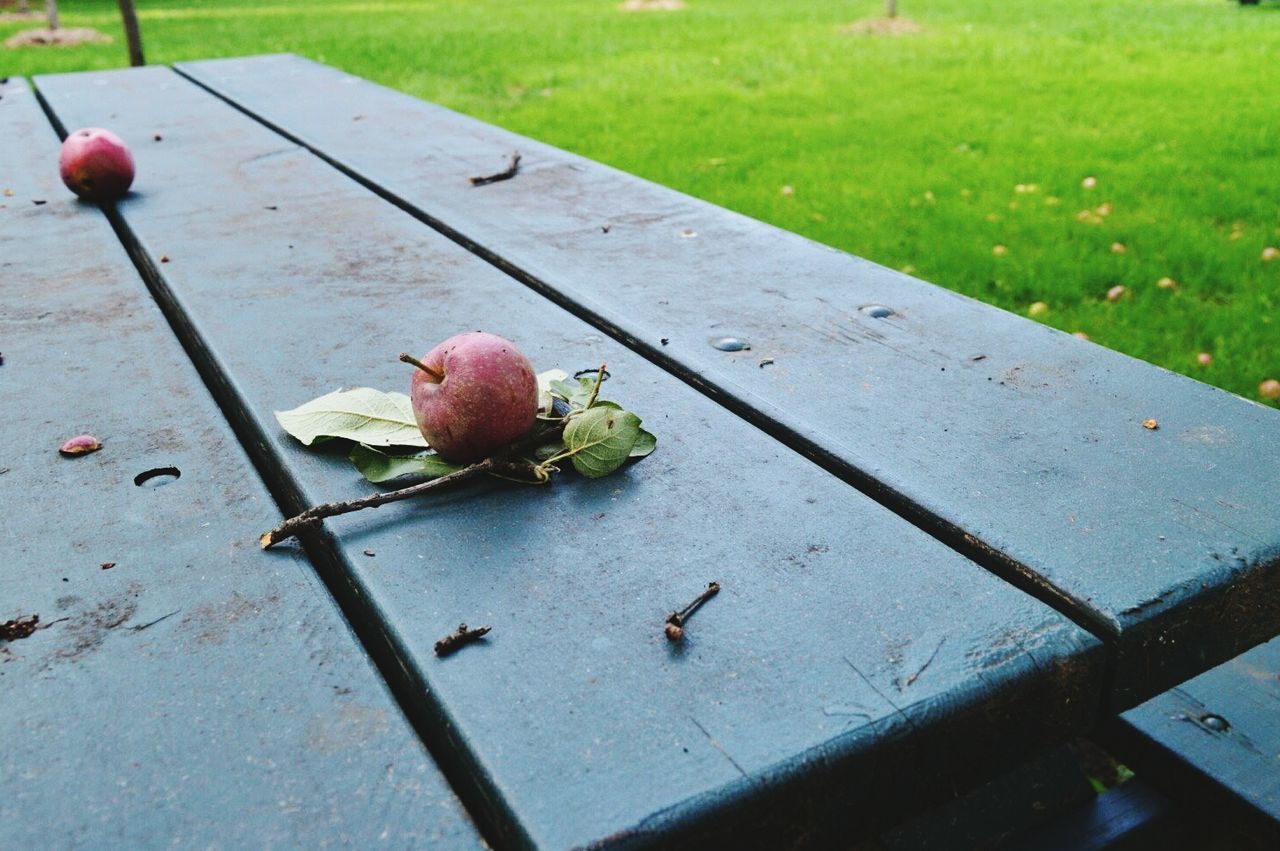 CLOSE-UP OF FRUITS ON TABLE AGAINST WALL