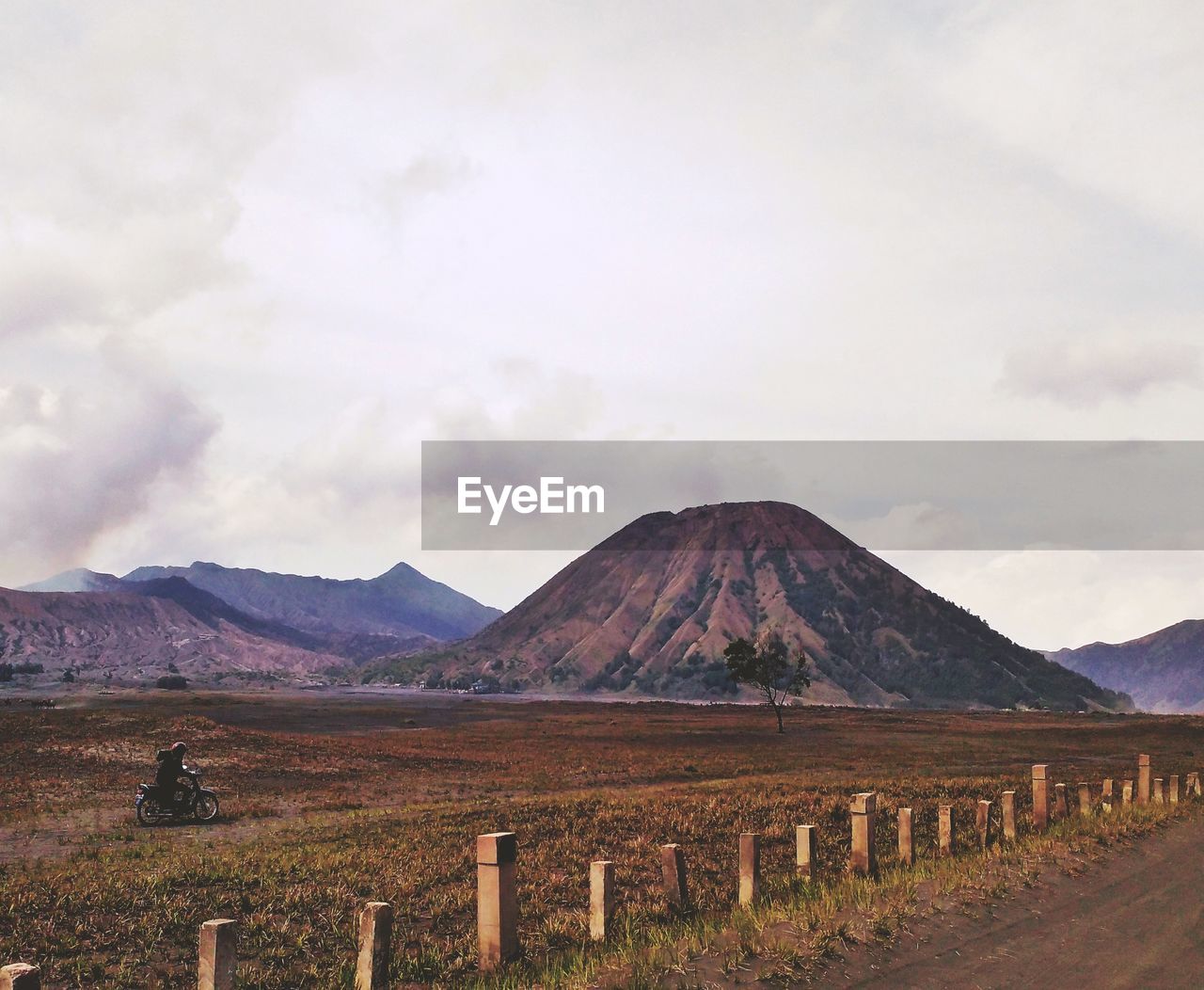 Scenic view of field and mountains against sky