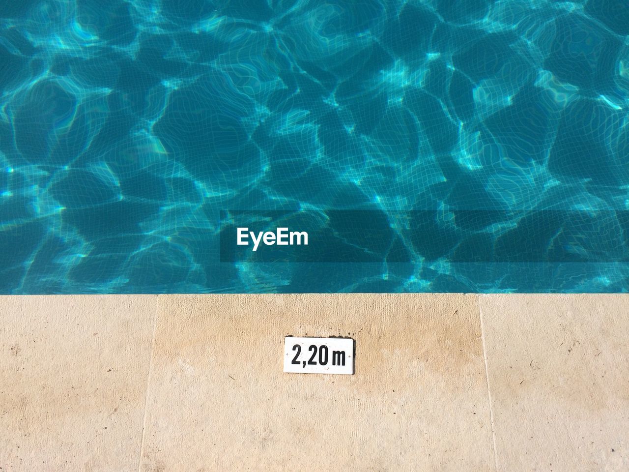HIGH ANGLE VIEW OF INFORMATION SIGN ON SWIMMING POOL