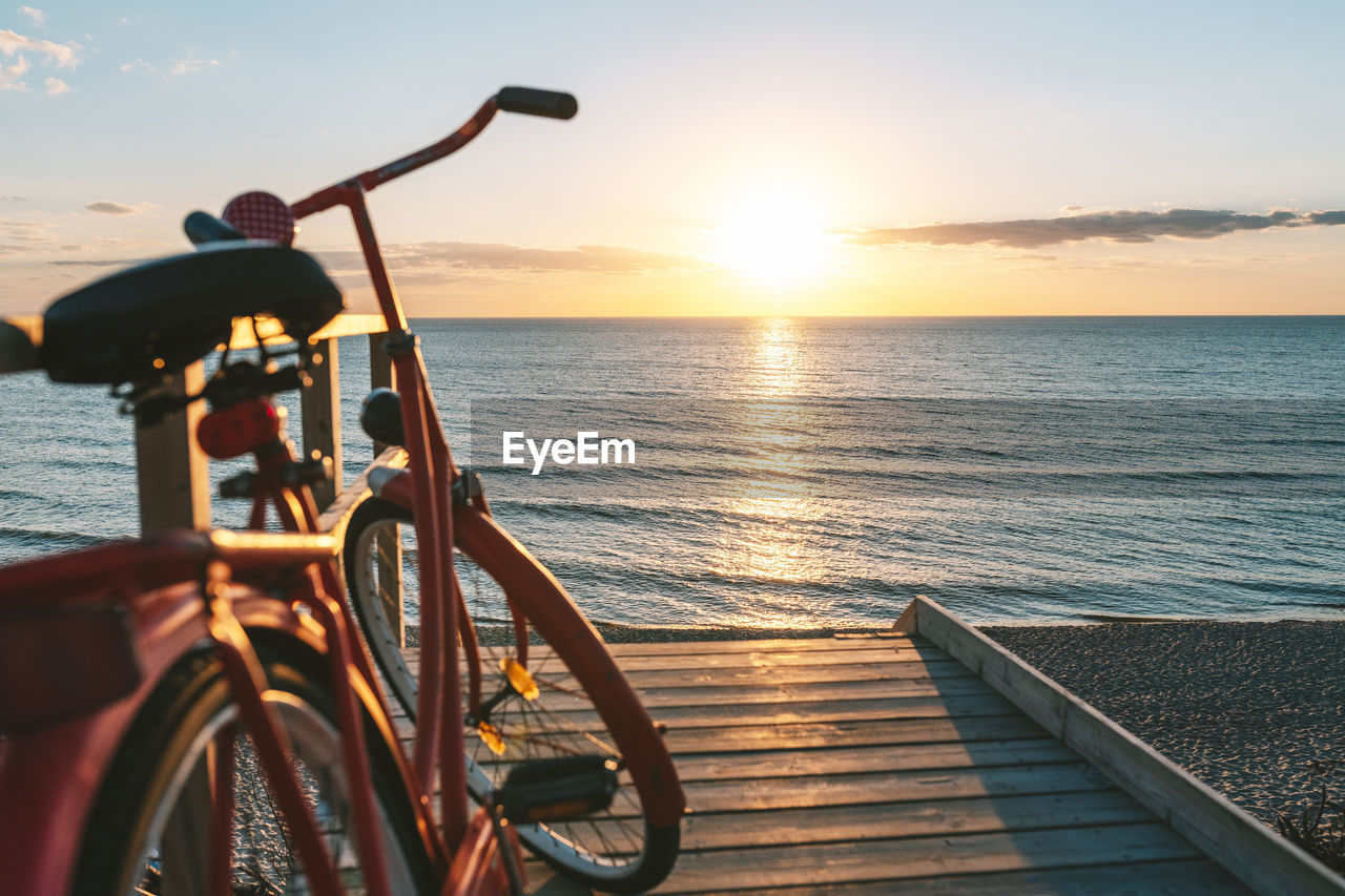 BICYCLE BY SEA DURING SUNSET