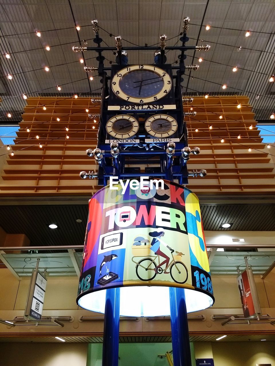 LOW ANGLE VIEW OF ILLUMINATED LIGHTING EQUIPMENT HANGING ON CEILING