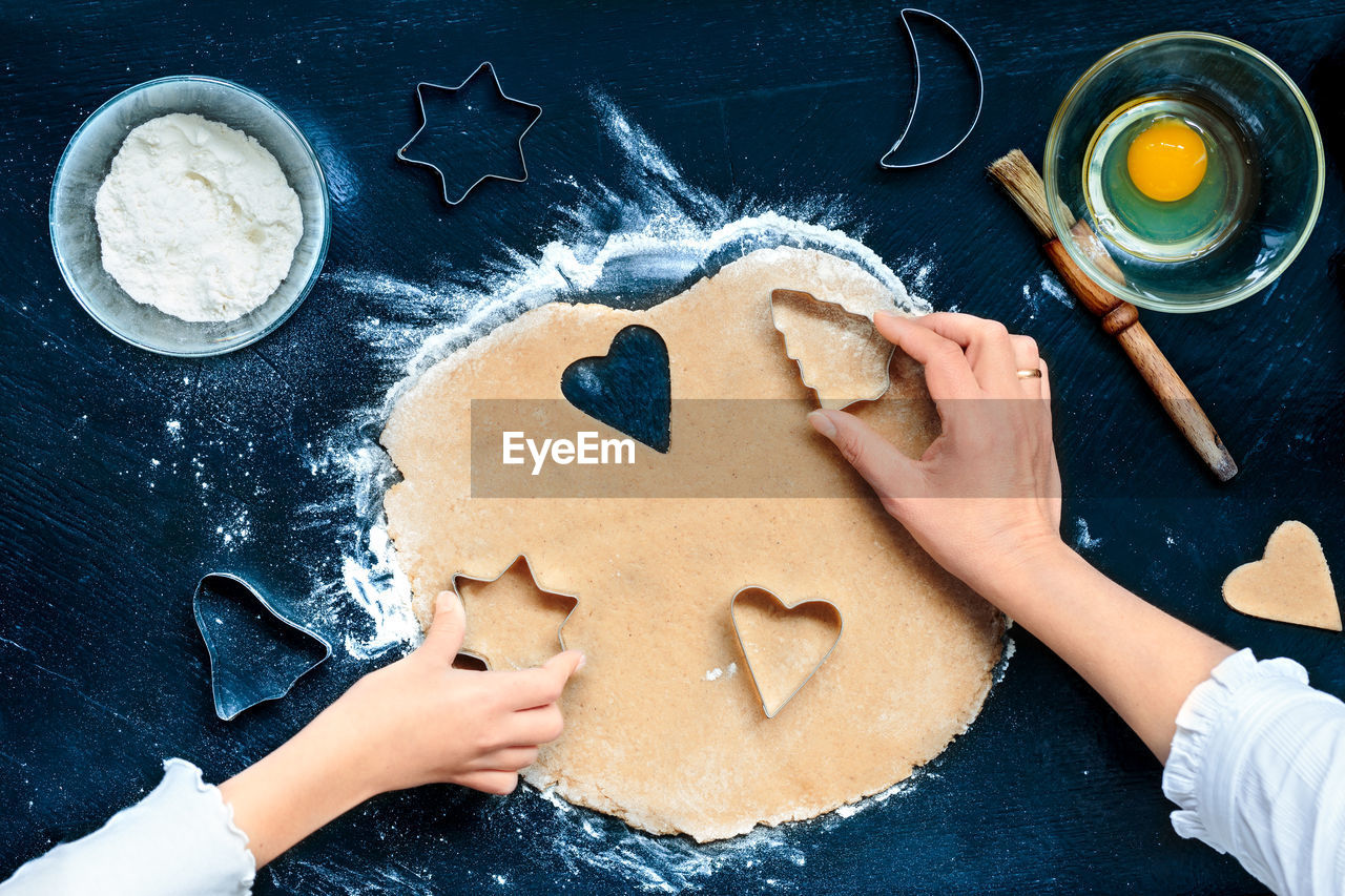 High angle view of woman and child making cookies