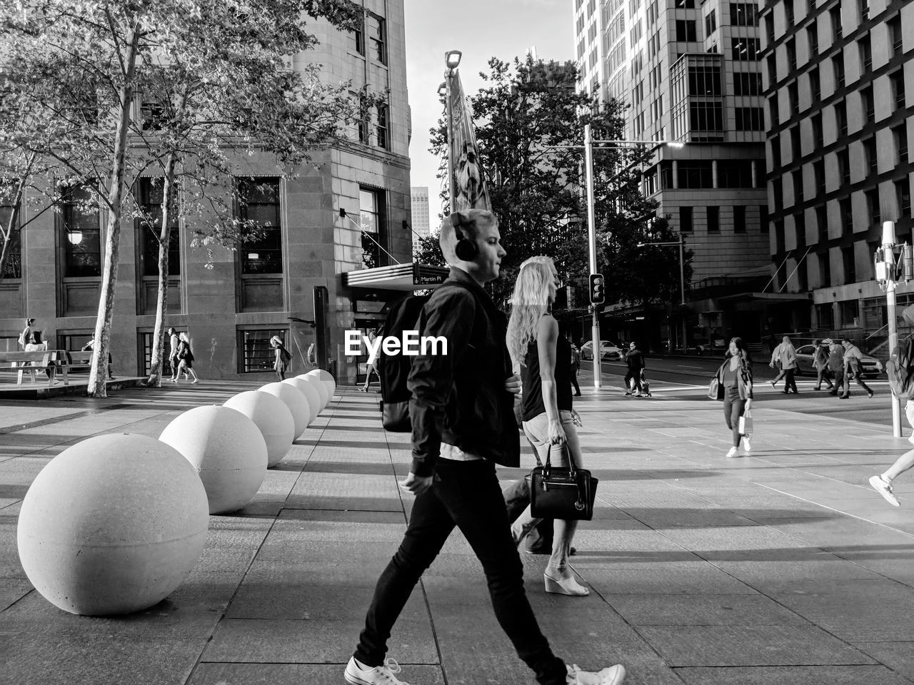 PEOPLE WALKING ON ZEBRA CROSSING IN CITY