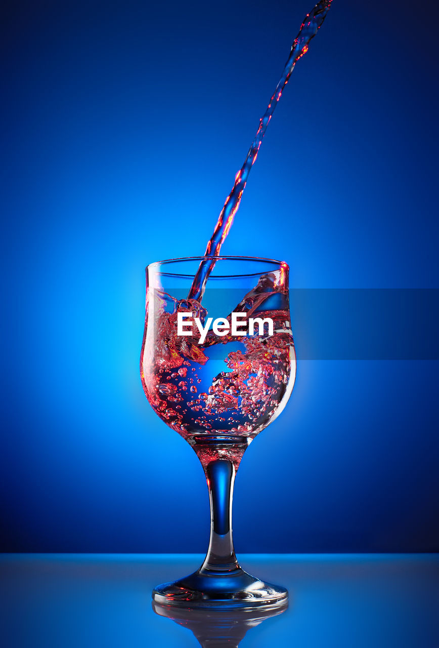 Close-up of drink over blue background