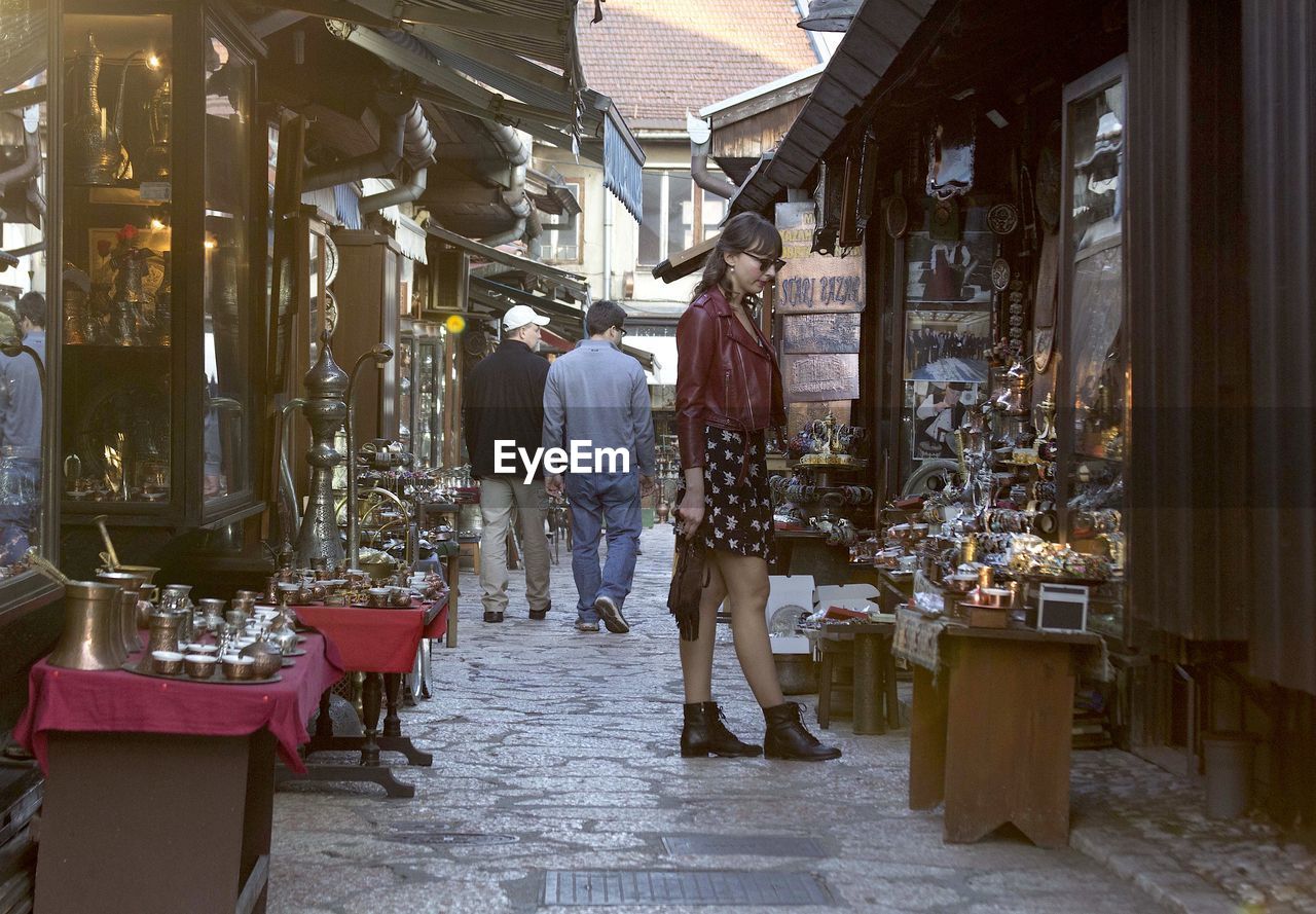 PEOPLE STANDING AT MARKET