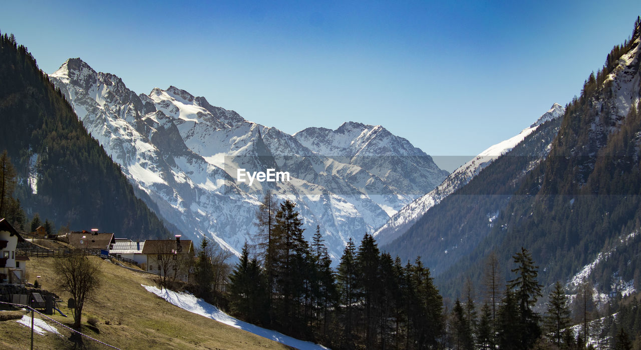 Scenic view of snowcapped mountains against clear sky