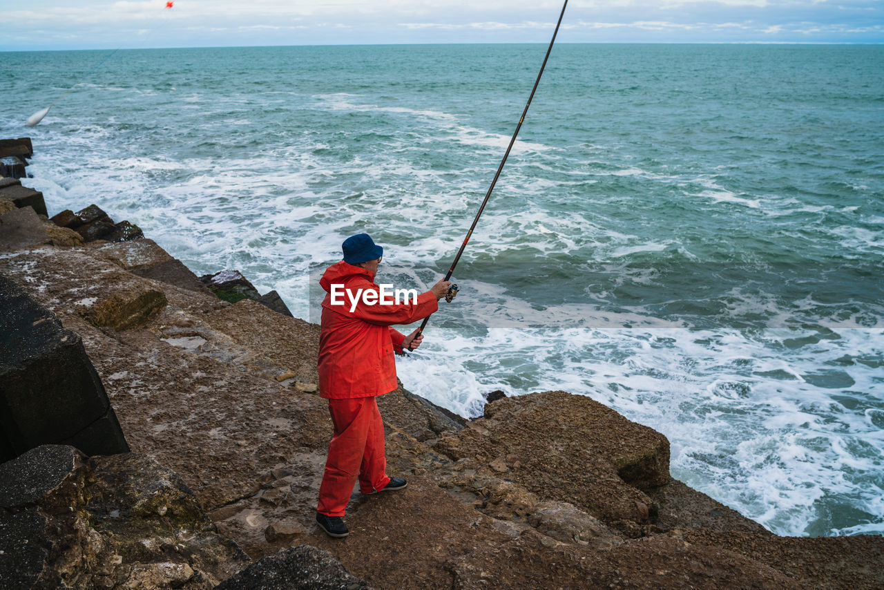 High angle view of man fishing in sea
