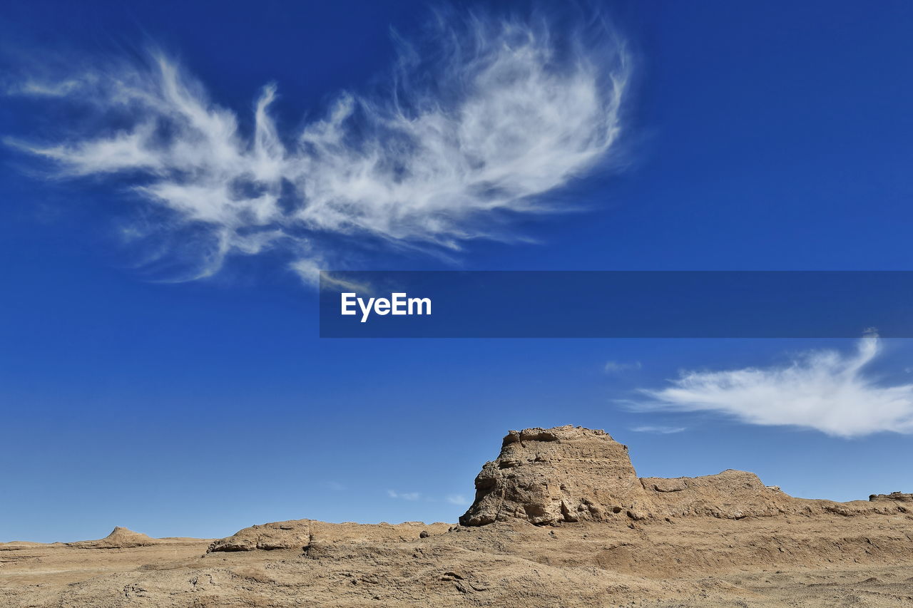 LOW ANGLE VIEW OF ROCKS AGAINST BLUE SKY