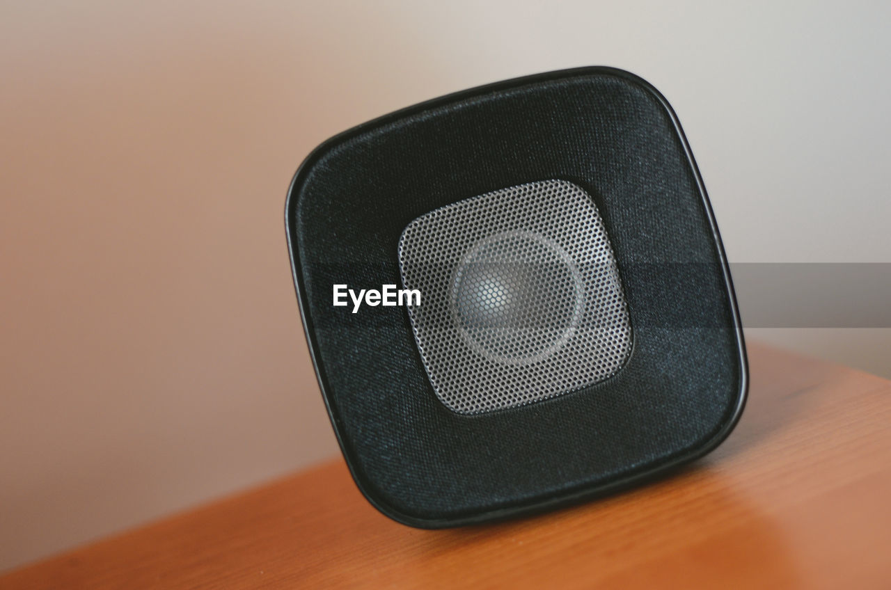 Close-up of speaker on table at home
