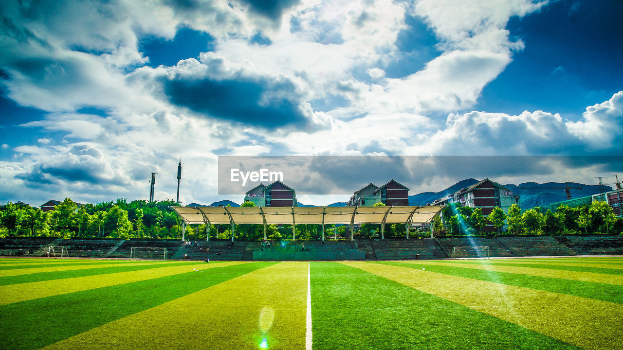 VIEW OF SOCCER FIELD AGAINST BUILDINGS