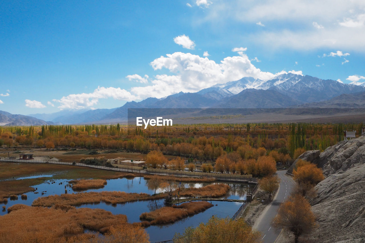 Scenic view of lake and mountains against sky