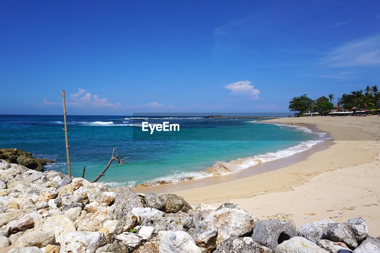 Scenic view of beach against blue sky