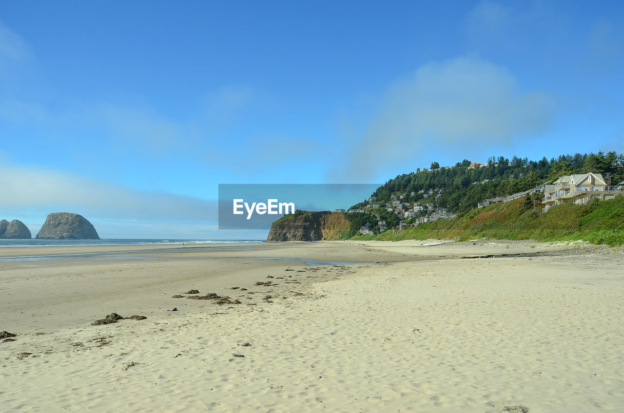 Scenic view of beach against blue sky